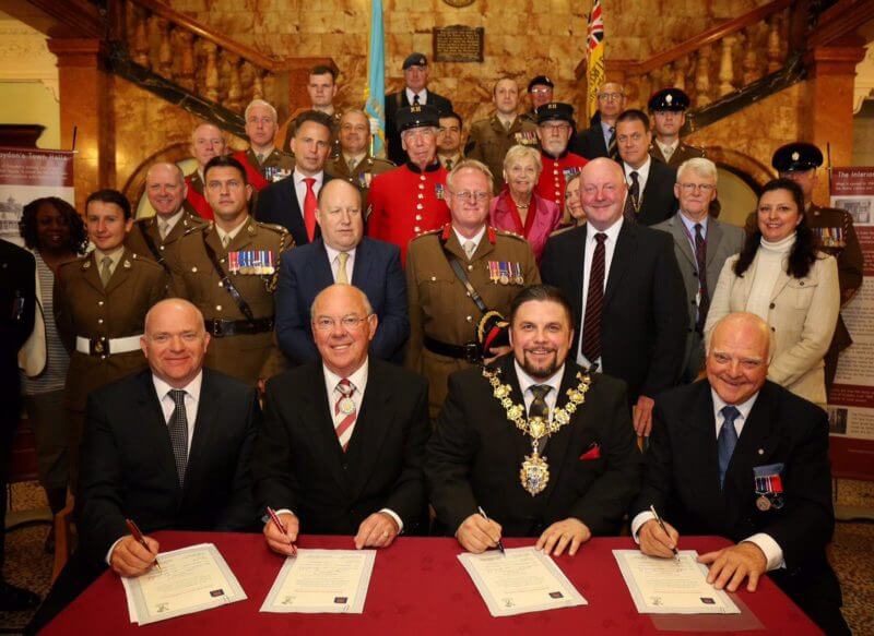 An image of the Rowland Brother's team signing the Armed Forces Covenant with the military and dignities in attendance.