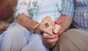 Image of older couple holding hands for a blog about an elderly gentleman's bereavement experience