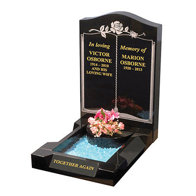 image of a black granite small kerb memorial with coral, tassel and book ornament and splay kerbs for a product listing for a small kerb memorial