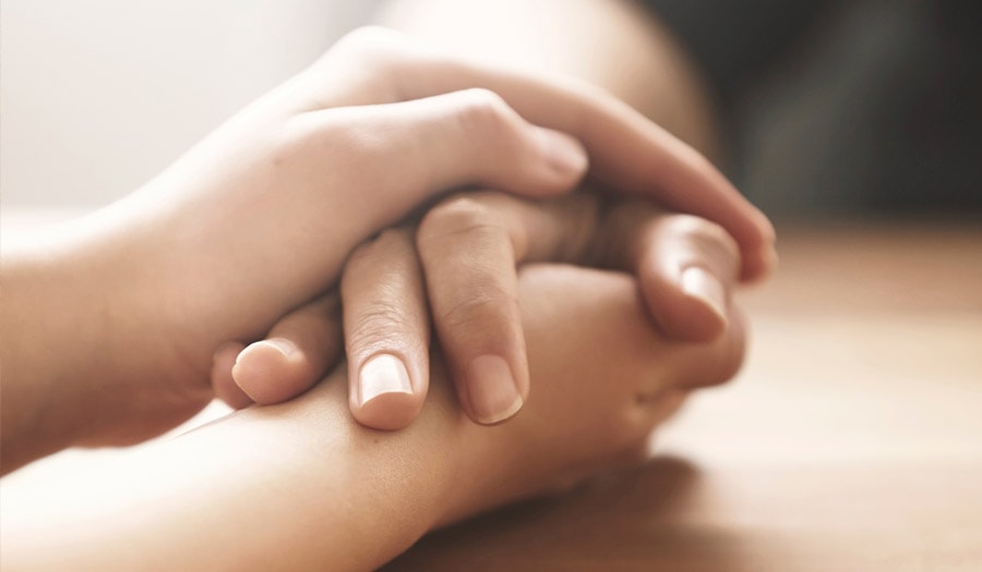 Funeral Directors Croydon - Image of holding hands for rowland brothers bereavement support services in croydon