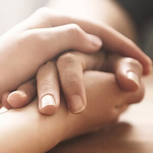 Image of holding hands for rowland brothers bereavement support services in croydon