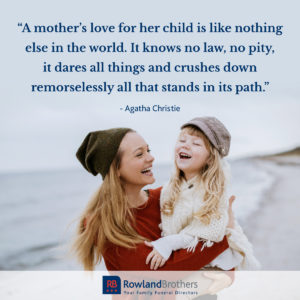 image of a mother holding her daughter at the beach with a quote from agatha christie