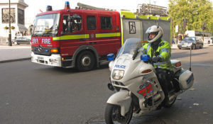 image of policeman and firetruck for a blog about caring for emergency services