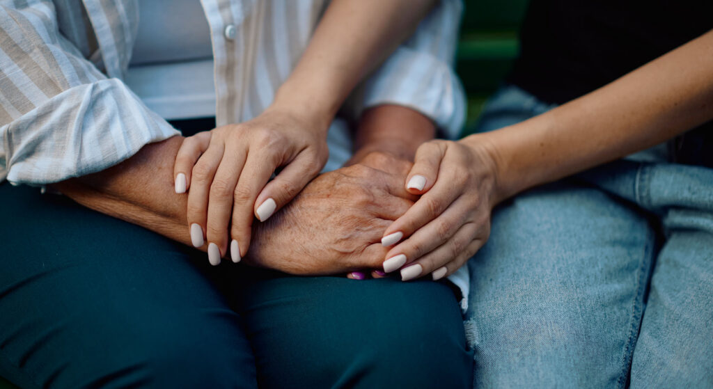 Hands comforting the bereaved.