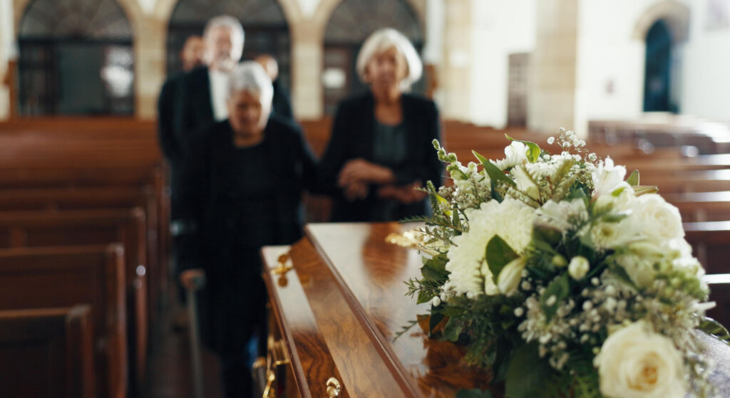 Funeral, church and people with coffin for goodbye, mourning and grief in memorial service.