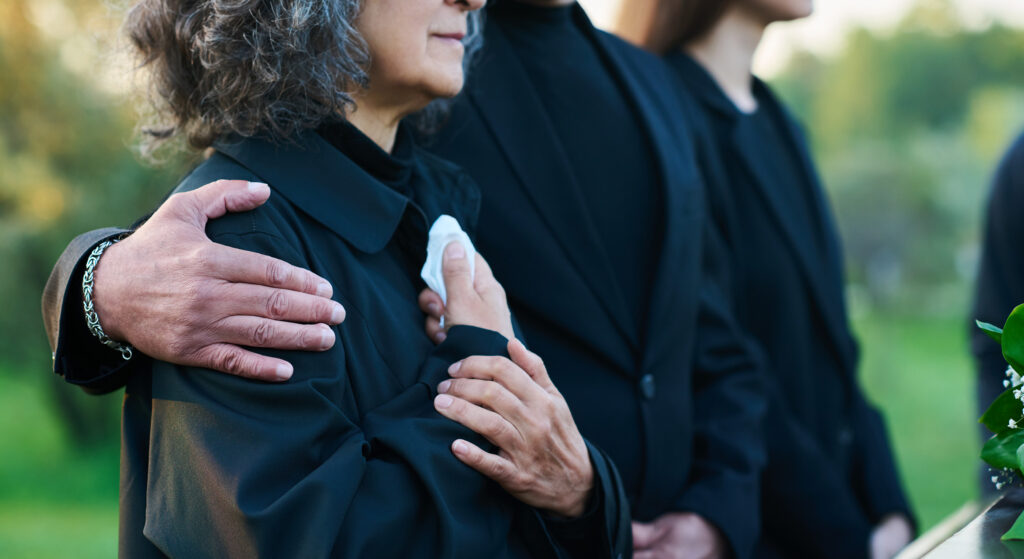Mourning family in dark clothing.